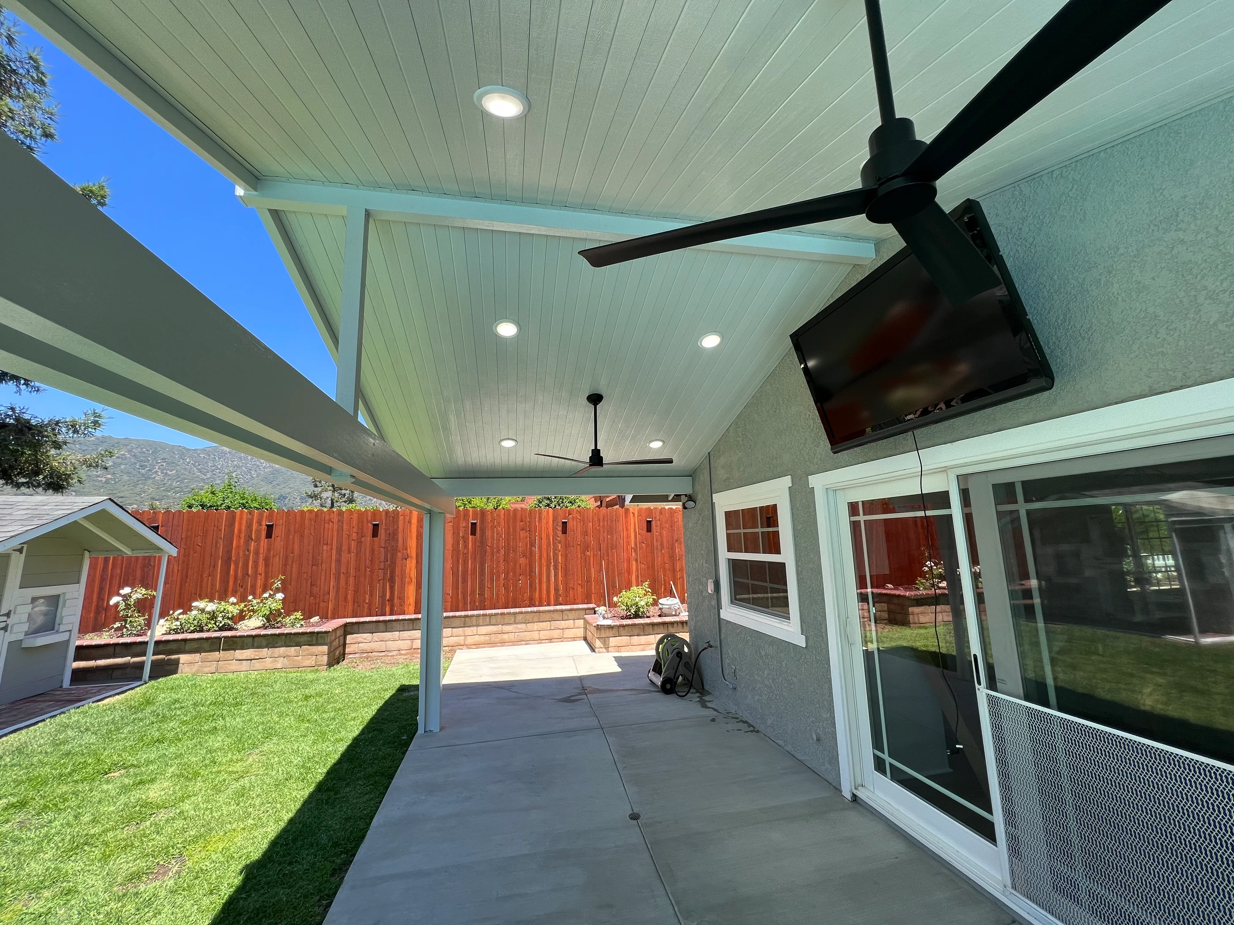 Covered patio with metal frame, LED lights, ceiling fan, and concrete flooring